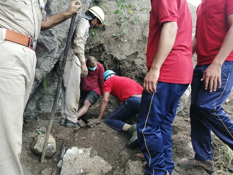 Police personnel carry out rescue operations at the site.