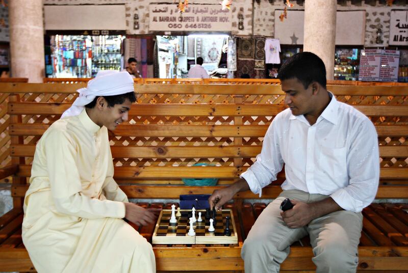 SHARJAH, UNITED ARAB EMIRATES Ð July 27: Left to Right- Saad Saeed Mohammed one of the shop owners son from Yemen playing chess with Mohammed Titu Mizan during the free time in the souq at Heritage area in Sharjah. Mohammed Titu Mizan is from Chittagong in Bangladesh and working as a sales person at Saad Saeed Mohammed fatherÕs shop. He is looking after carpet and antique shop at the heritage area in Sharjah. He came to UAE 6 years back. (Pawan Singh / The National) For News. A Week In Feature