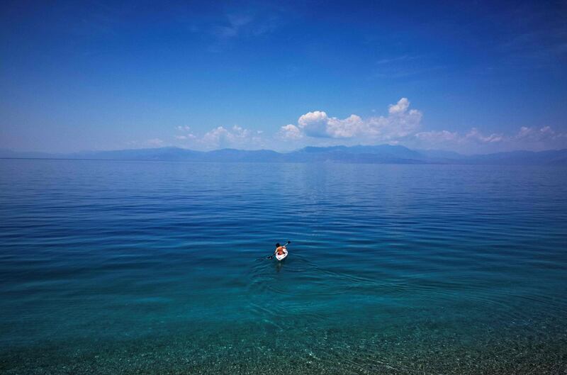 A young boy is canoeing at the beach of Derveni village, some 120 kilometres southwest of Athens.  AFP