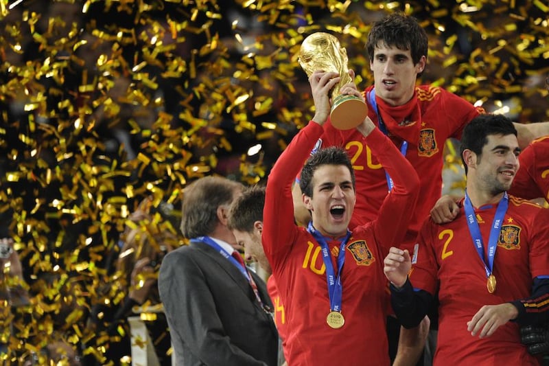 Cesc Fabregas holds aloft the World Cup after helping the senior team win in 2010. Javier Soriano / AFP