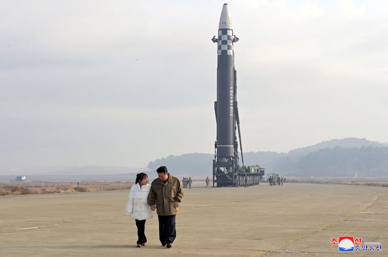 North Korean leader Kim Jong-un and a girl purported to be his daughter attend the launch of a Hwasongpho-17 ballistic missile. Reuters