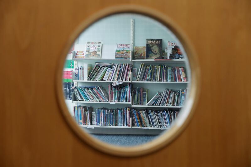 Books are seen through the window of the closed library as staff make preparations for Watlington Primary School to reopen to children on June 1, following the outbreak of the coronavirus disease (COVID-19), Watlington, Britain, May 21, 2020. REUTERS/Eddie Keogh