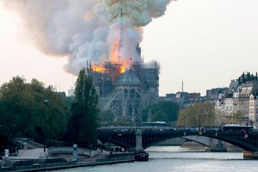 Smokes ascends as flames rise during a fire at the landmark Notre-Dame Cathedral in central Paris on April 15, 2019 afternoon, potentially involving renovation works being carried out at the site, the fire service said. AFP