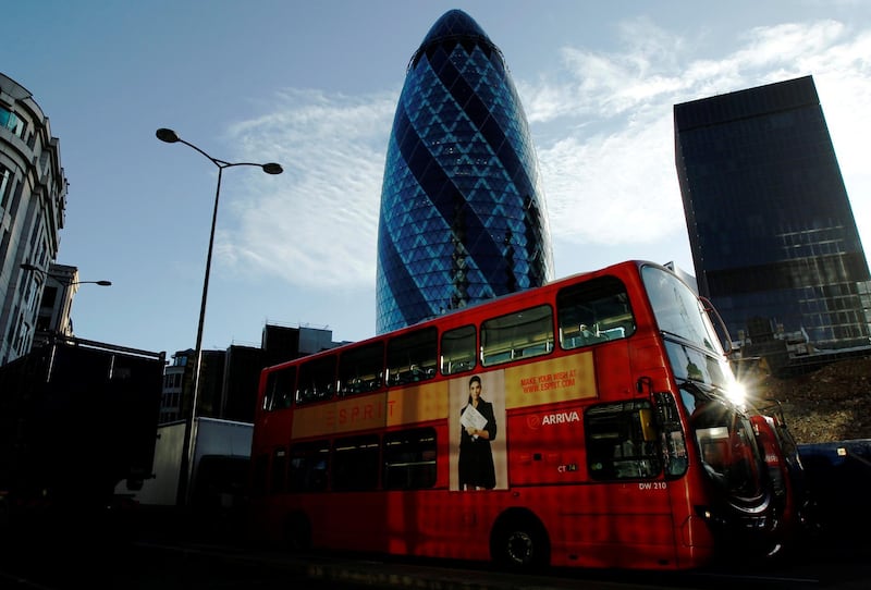 FILE PHOTO: An Arriva London bus passes the Swiss Re building known as the Gherkin in the City of London December 9, 2011.  REUTERS/Luke MacGregor/File Photo