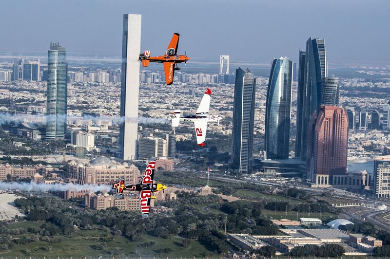 Matthias Dolderer of Germany leads Martin Sonka of Czech Republic and Nicolas Ivanoff of France along the skyline of the city of Abu Dhabi before the first stage of the Red Bull Air Race World Championship, United Arab Emirates on February 6, 2017. // Predrag Vuckovic/Red Bull Content Pool // P-20170207-00378 // Usage for editorial use only // Please go to www.redbullcontentpool.com for further information. // 