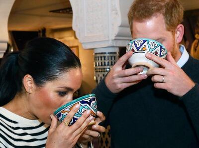 Britain's Prince Harry and Meghan, Duchess of Sussex, drink from bowls as they visit a cooking school demonstration at the Villa des Ambassadors in Rabat, Morocco, Monday Feb. 25, 2019.  The royal couple sampled food, where children from under-privileged backgrounds learn traditional Moroccan recipes from one of Moroccos foremost chefs. (Tim P. Whitby/Pool via AP)