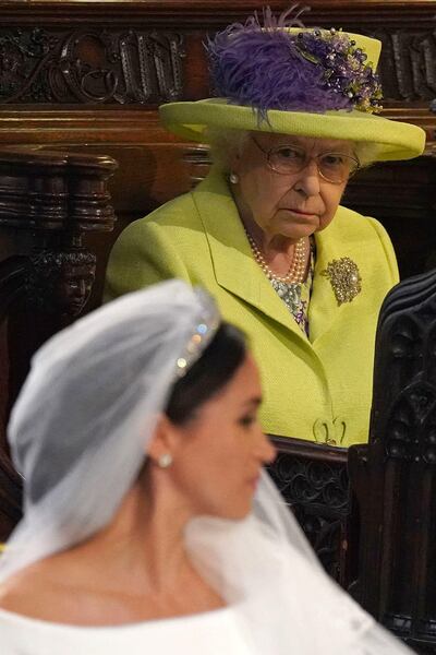 (FILES) In this file photo taken on May 19, 2018 Britain's Queen Elizabeth II looks on during the wedding ceremony of Britain's Prince Harry, Duke of Sussex and US actress Meghan Markle in St George's Chapel, Windsor Castle, in Windsor, west of London. Prince Harry and his celebrity wife Meghan's bombshell resignation from front-line royal duties rocked the British monarchy on Thursday, with reports suggesting Queen Elizabeth II had not been informed in advance. The couple said they would now "balance" their time between Britain and North America and rip up long-established relations with the press, in a surprise statement on January 8, 2020, that appeared to catch Buckingham Palace off guard. In a short, terse response a short time later, a palace statement said discussions with Harry and Meghan were "at an early stage". / AFP / POOL / Jonathan Brady
