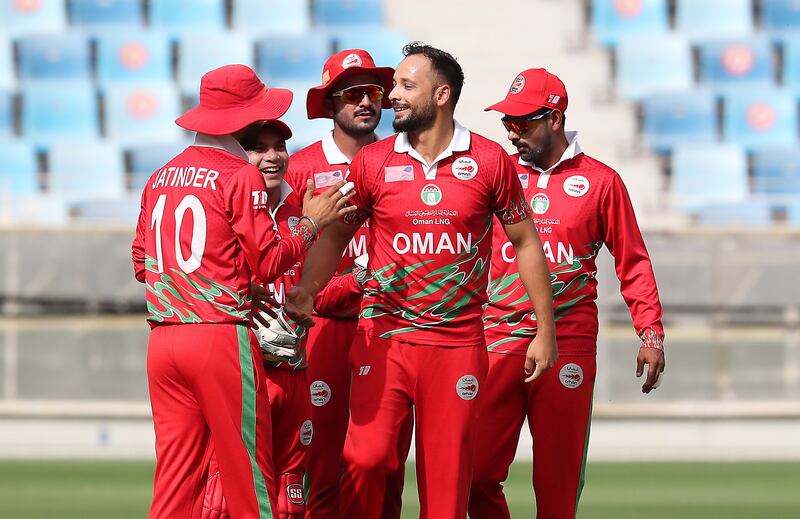Oman's Fayyaz Butt celebrates after taking the wicket of Lega Siaka.