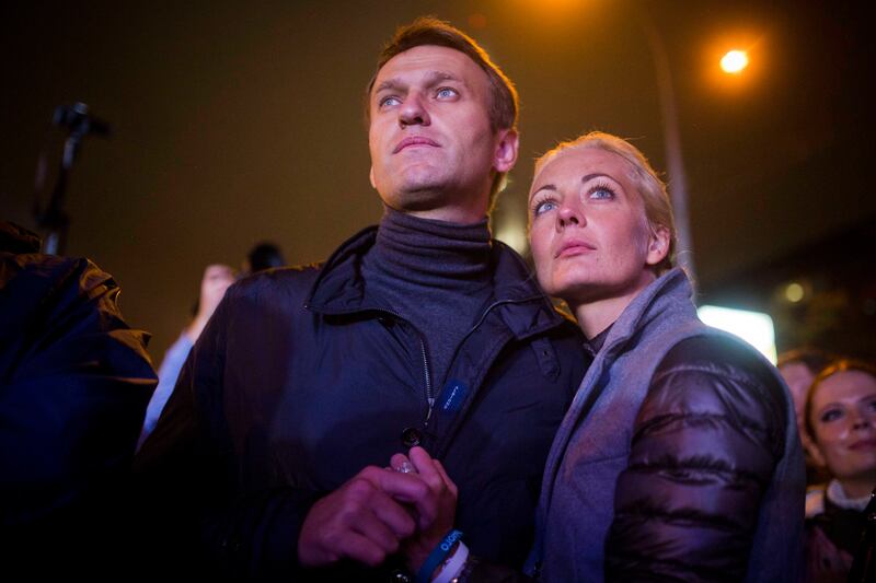 Mr Navalny with his wife Yulia after a rally in Moscow, in 2013. AP