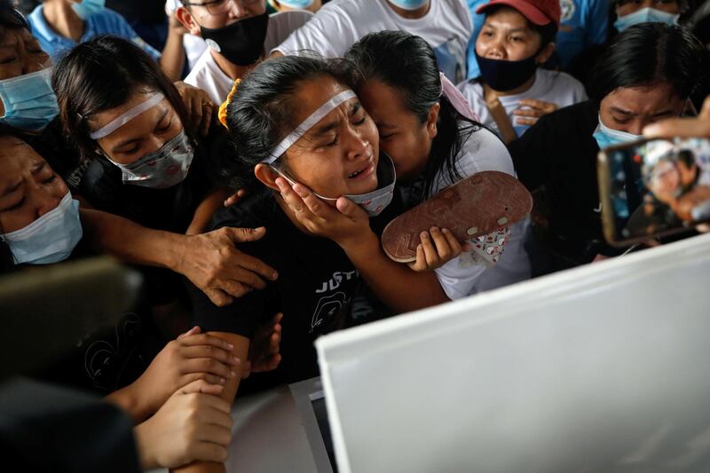 The family of mother and son Sonya and Frank Anthony Gregorio, who were shot and killed by an off-duty police officer, mourn over their caskets at their funeral, in Paniqui, Tarlac province, Philippines. Reuters