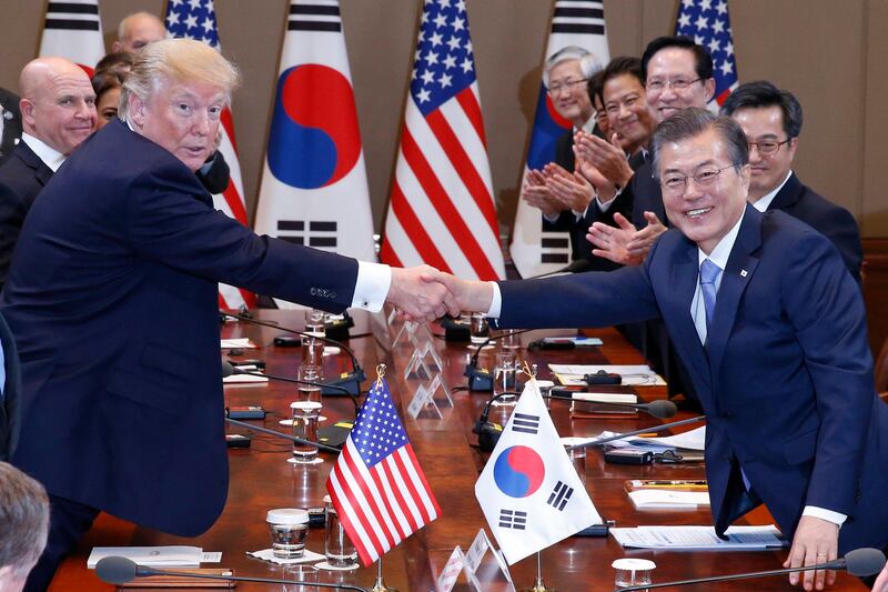 US president Donald Trump and South Korean president Moon Jae-in shake hands before their summit meeting at the presidential house in Seoul, South Korea. Jeon Heon-Kyun / EPA