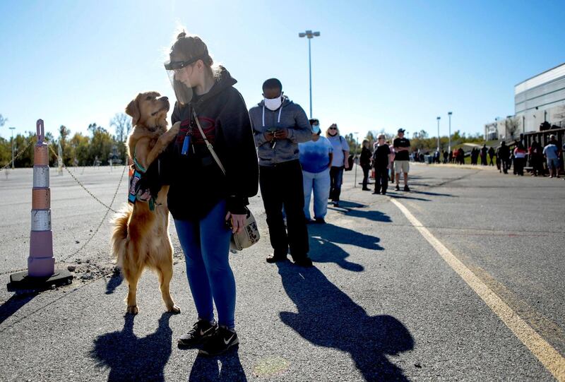 Aaryn Dupske waits in line, accompanied by her service dog, to vote in St. Charles, Missouri.  AP