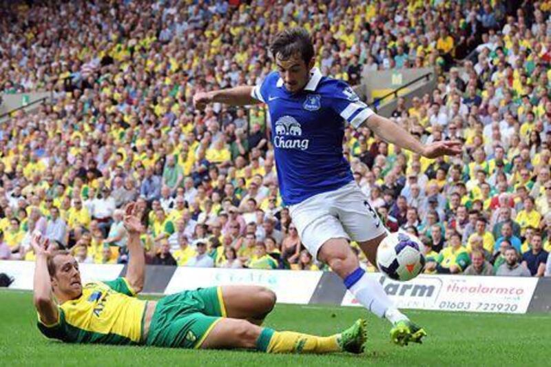 NORWICH, ENGLAND - AUGUST 17: Steven Whittaker of Norwich City tackles Leighton Baines of Everton during the Barclays Premier League match between Norwich City and Everton at Carrow Road on August 17, 2013 in Norwich, England. (Photo by Tony Marshall/Getty Images)