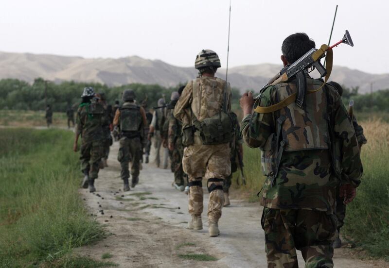 HELMAND PROVINCE, AFGHANISTAN - JUNE 1: British Army Officer, Captain Alex Corbet Burcher from the 1st Battalion Welsh Guards Regiment,attached to the Inkerman Company, 1st Battalion Grenadier Guards Regiment patrols with ANA (Afghan National Army) Soldiers his area of operation  during "Lastay Kulang" Operation" on June 1, 2007 in Sangin Valley, Helmand Province, Afghanistan. British troops from The Inkerman Company, 1st Battalion Grenadier Guards, part of ISAF Task Force Helmand, are mentoring the Afghan National Army while conducting security operations on behalf of the Government of Afghanistan in Helmand Province.(Photo by Marco Di Lauro/Getty Images)