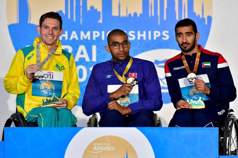 The UAE's Mohamed al Hammadi, right, shows off his bronze medal alongside Men's T34 final winner Walid Ktila, centre, of Tunisia and Australian runner-up Rheed McCracken. Courtesy International Paralympic Committee/ Luc Percival 