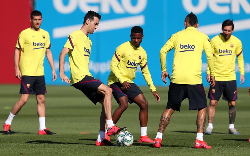 Sergio Busquets and Ansu Fati compete for the ball during a training session at Ciutat Esportiva Joan Gamper. Getty Images