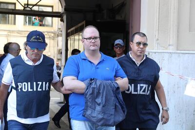 epa07722040 Two policemen escort Salvatore Gambino (C) arrested in Palermo, Italy, 17 July 2019 after a police/FBI operation code-named 'New Connection', targeted the Inzerillo clan, a Palermo group that was decimated by late Cosa Nostra 'boss of bosses' TotÃ² Riina in a turf war in the 1980s. Italian police and the FBI arrested 19 people in a big joint operation on Wednesday after a probe revealed alleged ties between Sicily's Cosa Nostra mafia and New York's Gambino Crime Family.  EPA/IGOR PETYX