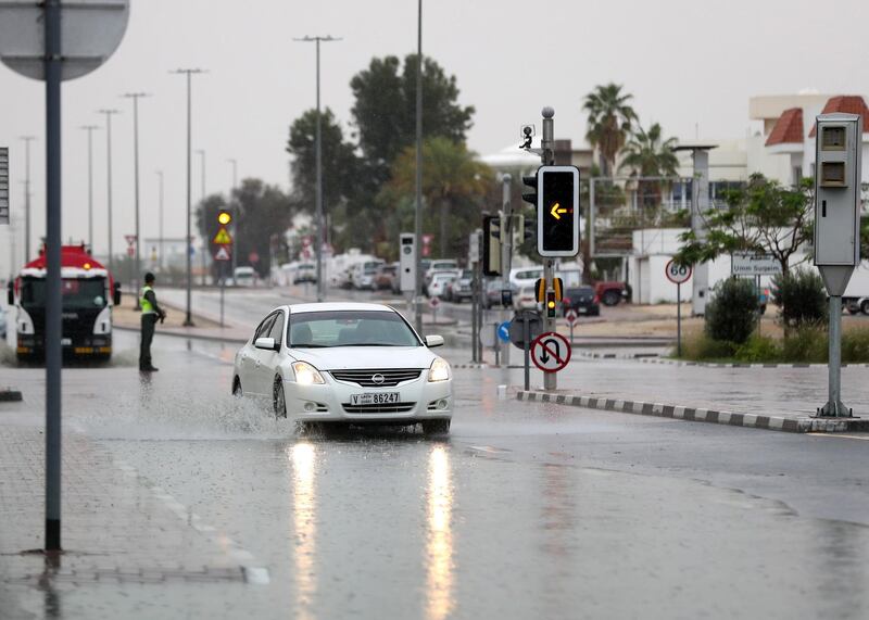 Dubai, United Arab Emirates - Reporter: N/A: Weather. Cars go through puddles as the rain comes down in Dubai. Saturday, March 21st, 2020. Jumeirah, Dubai. Chris Whiteoak / The National