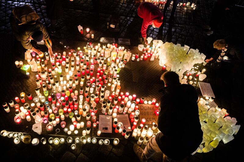 People place candles in Neumarkt Square, Dresden to commemorate the 1,400 lives lost to the coronavirus in the German city. AFP