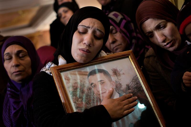 Palestinian women mourn during the funeral of Arafat Jaradat in the West Bank town of Saeer, near Hebron, Monday, Feb. 25, 2013. Thousands have attended the funeral procession of a 30-year-old Palestinian man who died under disputed circumstances in Israeli custody. Palestinian officials say autopsy results show Jaradat was tortured by Israeli interrogators, while Israeli officials say there's no conclusive cause of death yet and that more tests are needed. (AP Photo/Bernat Armangue) *** Local Caption ***  APTOPIX Mideast Israel Palestinians.JPEG-04b63.jpg