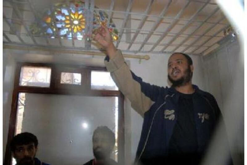Saleh al Shawish reacts from behind bars after he was sentenced to death by a court in Sana'a yesterday.