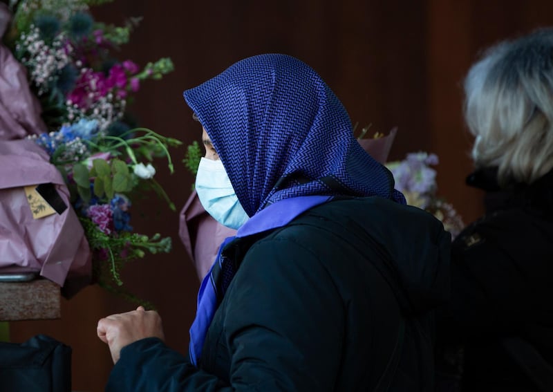 An Iranian woman gathers flowers to hand to lawyers. AP Photo