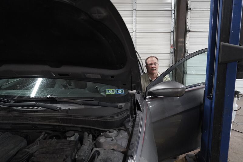 Michael Rodenhaber works on a car in his garage in York, Pennsylvania. Willy Lowry / The National.