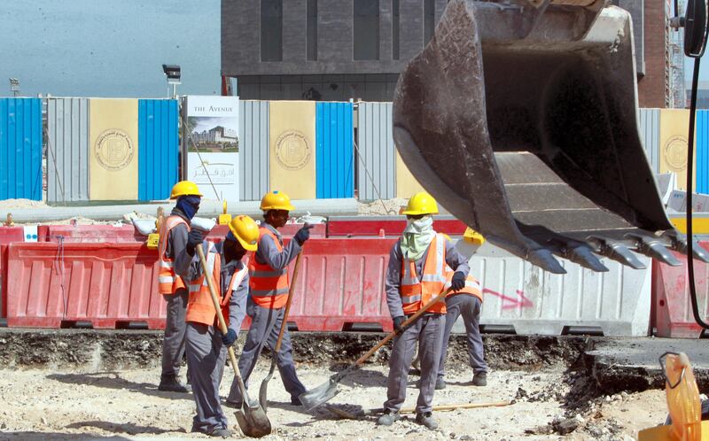 Workers are seen at a construction site in Doha, on November 16, 2014. Qatar, host of the 2022 football World Cup, pledged  to introduce new legislation to replace the controversial "kafala" sponsorship system and improve conditions for migrant workers by early 2015. The current law, which limits the rights of movement for foreign workers, would make way for legislation that was "currently under review," said the labour and social affairs ministry.  AFP PHOTO/STR / AFP PHOTO / -