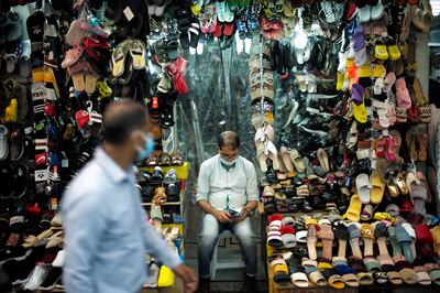 A salesman wearing a face mask outside his shop in a local Souq in Bab Al-Bahrain in Bahrain. Photo: Reuters / Hamad I Mohammed