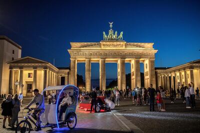 BERLIN, GERMANY - JULY 24: Tourists gather at the Brandenburg gate in Berlin on July 24, 2020 in Berlin, Germany. For the German capital, the COVID-19 pandemic has been economically devastating, as its liveihood depends on partygoers and tourism.  (Photo by Maja Hitij/Getty Images)