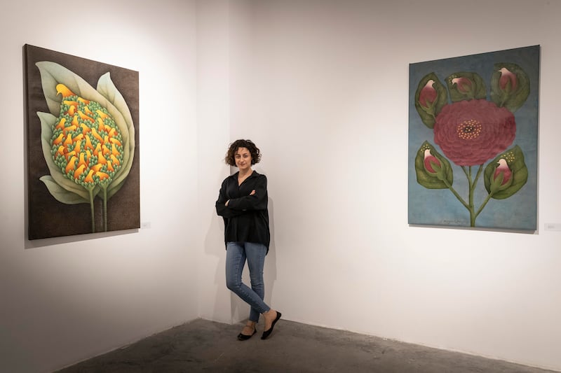 Lamei with her works in the Dubai space