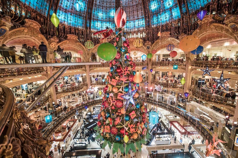 The traditional Christmas tree of the Galeries Lafayette department store stands under its great dome in Paris. French stores can reopen starting November 28 after several weeks of lockdown.  EPA