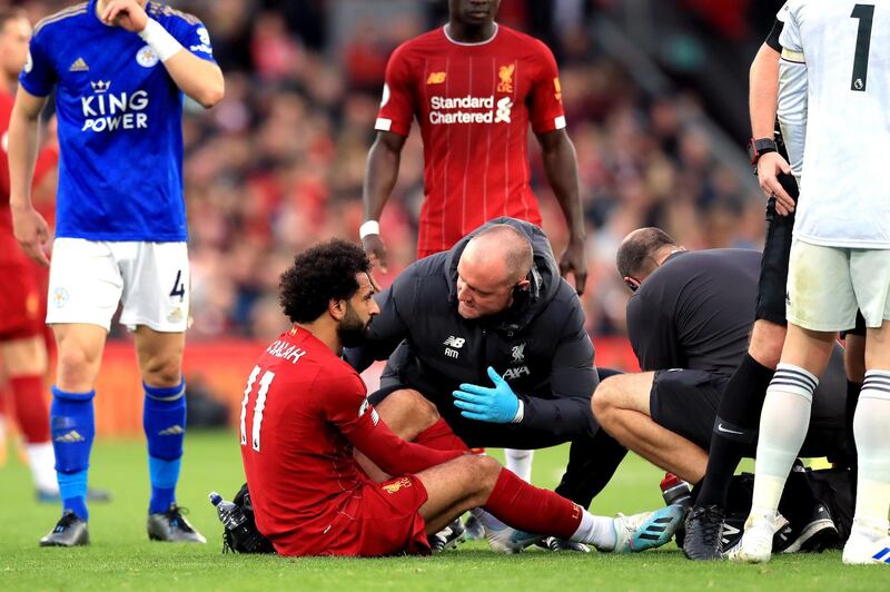 Liverpool's Mohamed Salah is attended to by medical staff. Press Association