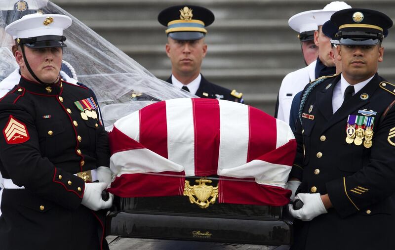 The flag-draped casket of John McCain is carried to a hearse from the US Capitol in Washington. AP