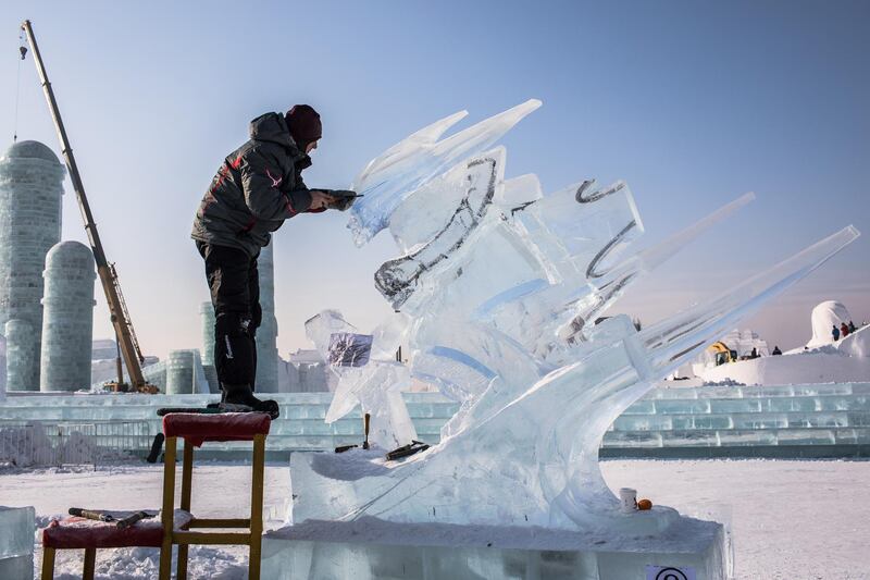 A participant carves his ice sculpture. EPA