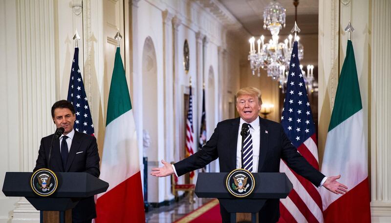 U.S. President Donald Trump, right, speaks as Giuseppe Conte, Italy's prime minister, listens during a news conference in the East Room of the White House in Washington, D.C., U.S., on Monday, July 30, 2018. Conte took his cues from Donald Trump at their first White House meeting, backing the president's views on trade, migration, security and defense spending and setting himself up as an advocate for U.S. policy in the heart of the European Union. Photographer: Al Drago/Bloomberg