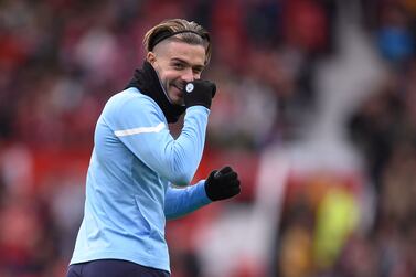 Manchester City's English midfielder Jack Grealish warms up ahead of the English Premier League football match between Manchester United and Manchester City at Old Trafford in Manchester, north west England, on November 6, 2021.  (Photo by Oli SCARFF / AFP) / RESTRICTED TO EDITORIAL USE.  No use with unauthorized audio, video, data, fixture lists, club/league logos or 'live' services.  Online in-match use limited to 120 images.  An additional 40 images may be used in extra time.  No video emulation.  Social media in-match use limited to 120 images.  An additional 40 images may be used in extra time.  No use in betting publications, games or single club/league/player publications.   /  