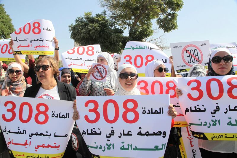 Women activists protest in front Jordan's parliament in Amman on Tuesday, August 1, 2017 with banners calling on legislators to repeal a provision that allows a rapist to escape punishment if he marries his victim.Â Parliament is to vote on the proposed change to the penal code Tuesday. The  banner in the middle in Arabic reads: Article 308 is a disgrace in the JordanianÂ justice system, the banner  on the left says: Article 308 does not protect honor, it protects the culprit. (AP Photo/Reem Saad)