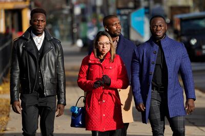 Lawyer Gloria Schmidt Rodriguez, centre, with her clients Abimbola Osundairo, left, and Olabinjo Osundairo. AP