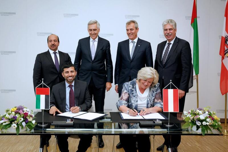 Suhail Al Mazrouei, UAE Minister of Energy and managing director of Ipic, and ÖBIB secretary-general Martha Oberndorfer sign the agreement in Vienna. Courtesy Ipic