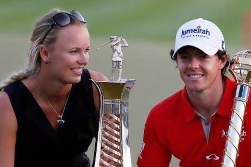 Northern Ireland's Rory McIlroy, right, poses with his girlfriend, Denmark's tennis player Caroline Wozniacki, after he won the DP World Tour Golf Championship in Dubai in November. Karim Shaib / AFP