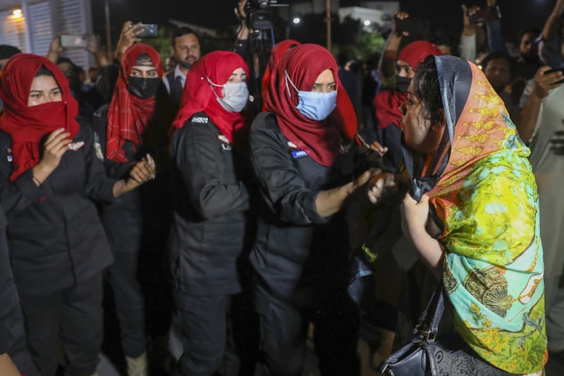 Policewomen detain supporters of Mr Khan. Bloomberg