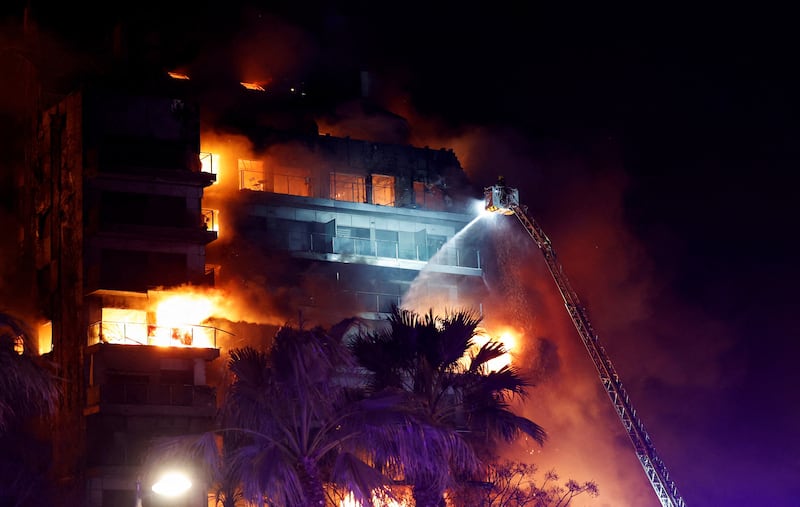 Firefighters try put out a blaze at an apartment building in Valencia, Spain. Reuters