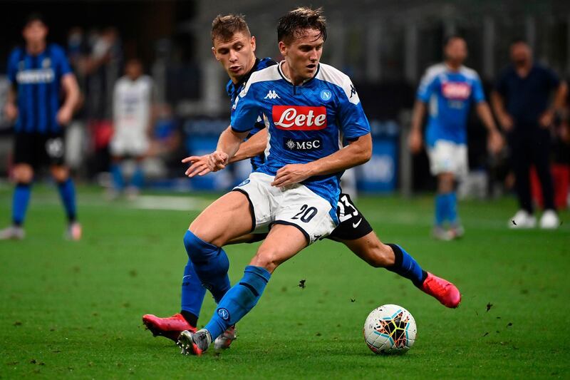 Inter Milan's Italian midfielder Nicolo Barella (back) vies with Napoli's Polish defender Piotr Zielinski. AFP