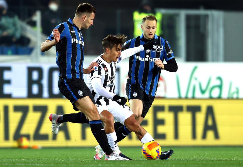 Paulo Dybala is challenged by Atalanta players Berat Djimsiti (L) and Teun Koopmeiners. EPA