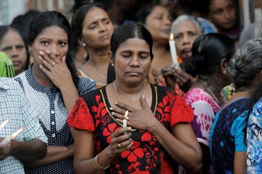 People react as silence is observed as a tribute to victims two days after a string of suicide bomb attacks on churches and luxury hotels across the island on Easter Sunday, during a memorial service in Colombo, Sri Lanka April 23, 2019. REUTERS/Dinuka Liyanawatte