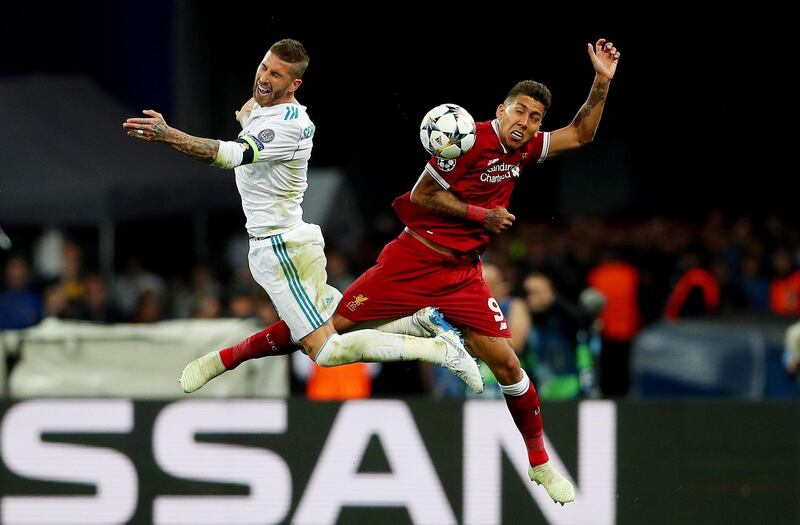 Liverpool's Roberto Firmino in action with Real Madrid's Sergio Ramos. Hannah McKay / Reuters