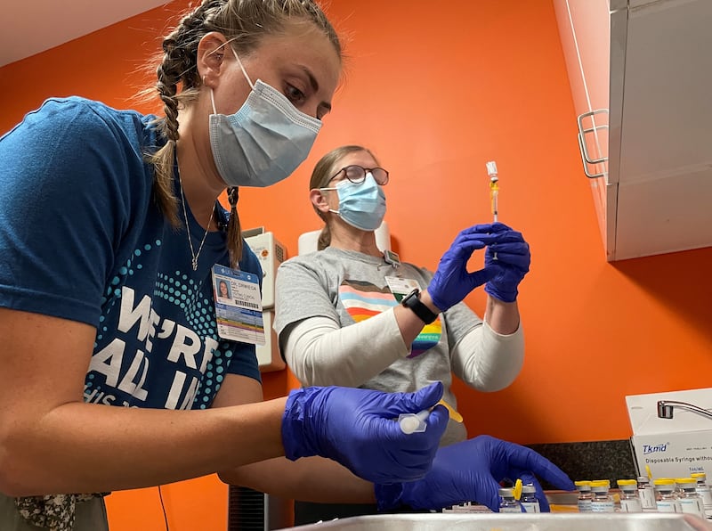 Dr  Emily Drwiega from the University of Illinois Health and Maggie Butler, a registered nurse, prepare monkeypox vaccines. Reuters