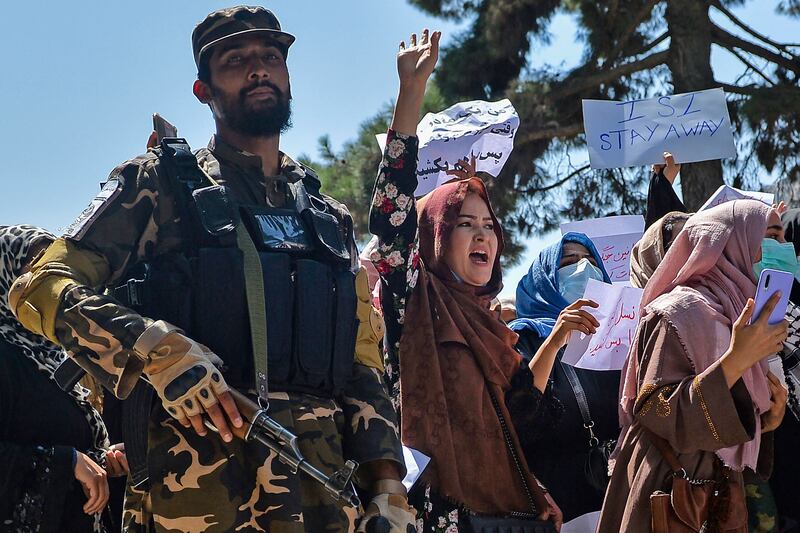 Afghan women shout slogans next to a Taliban fighter during an anti-Pakistan demonstration near the country's embassy in Kabul. AFP