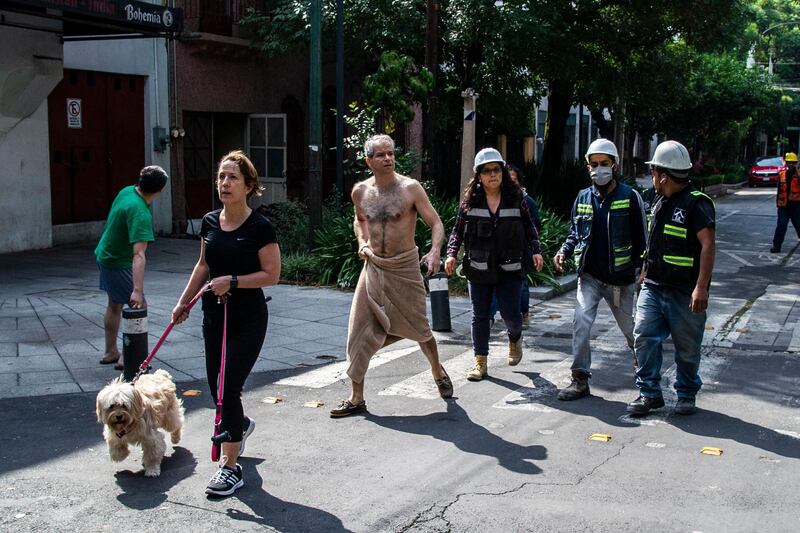 People get to the streets in Mexico City following a quake amid the COVID-19 novel coronavirus pandemic. A 7.1 magnitude quake was registered Tuesday in the south of Mexico, according to the Mexican National Seismological Service.   AFP